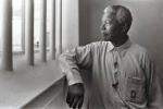 Nelson Mandela looking through prison bars to a brighter future for all
